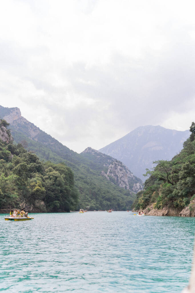 view of the Verdon Gorges from the pedal boat, other boats float on the Verdon vertical view